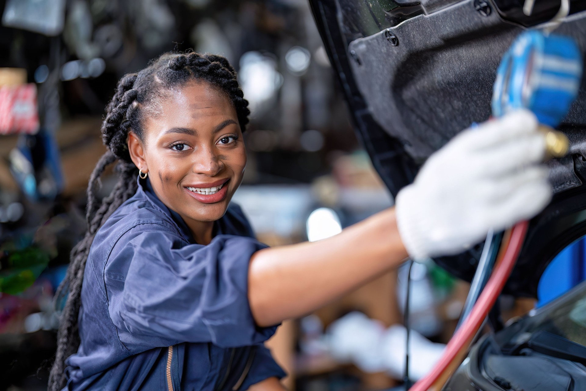 Mechanical girl dirty face wearing overall cover suit checking pressure vacuum gauge